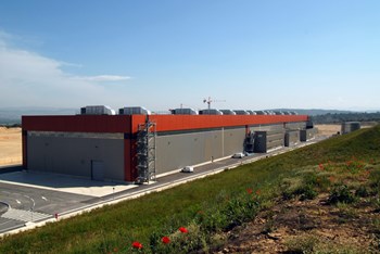 The first completed building on the ITER platform was the Poloidal Field Coils Winding Facility (2011). The European Domestic Agency built this facility for the winding and production of ITER's four largest poloidal field coils. Today, the building houses activities related to machine assembly. (Click to view larger version...)
